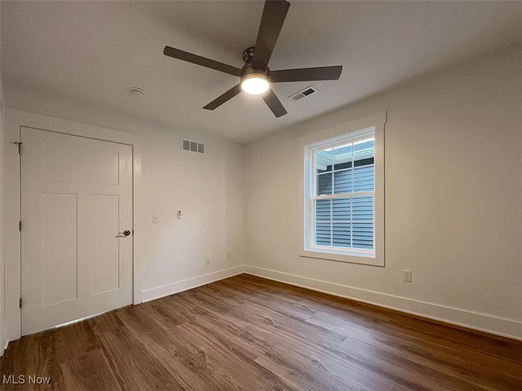 Master bedroom featuring wood finished floors and a ceiling fan