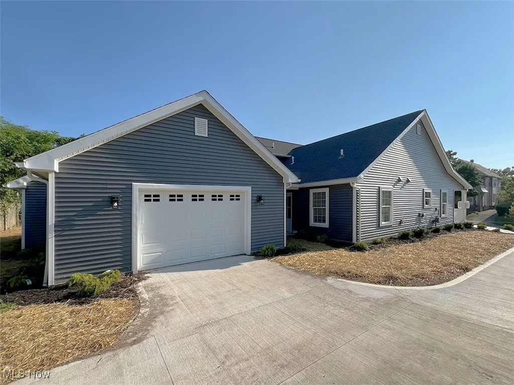 View of front facade with driveway and a garage