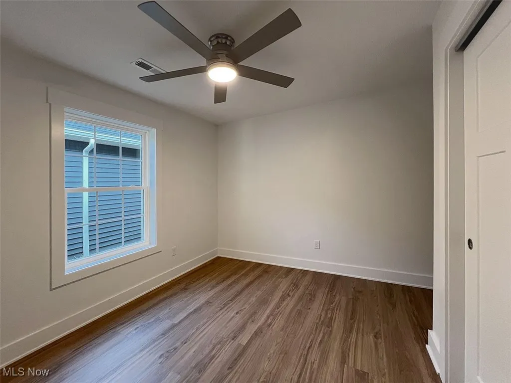 Master bedroom featuring dark wood-type flooring and ceiling fan