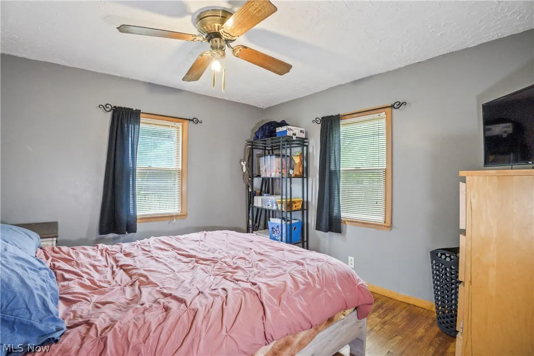 Bedroom featuring ceiling fan and hardwood / wood-style floors