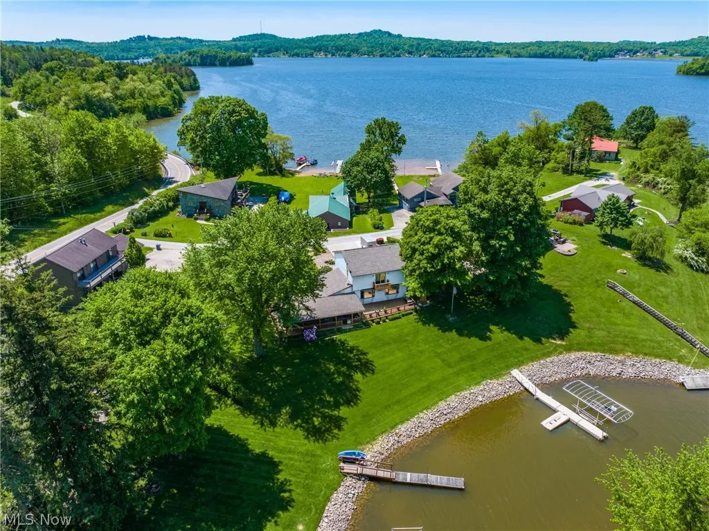 Birds eye view of property with a water view