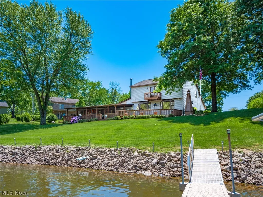 Dock area featuring a lawn and a water view