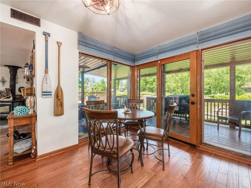 Dining space with hardwood / wood-style flooring