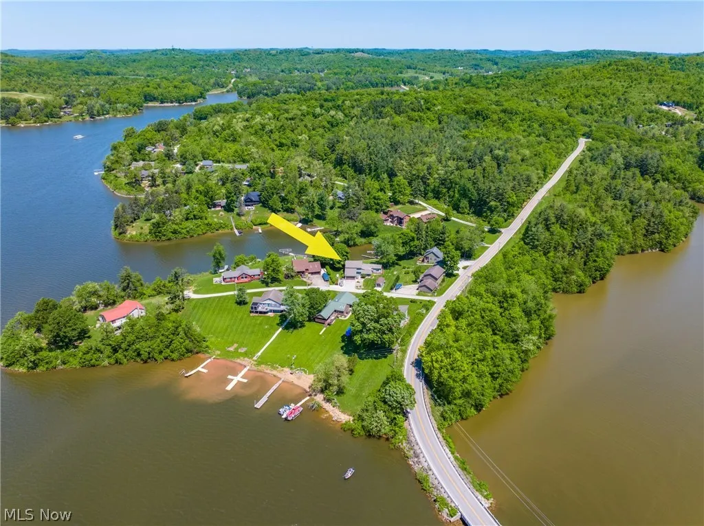 Birds eye view of property with a water view
