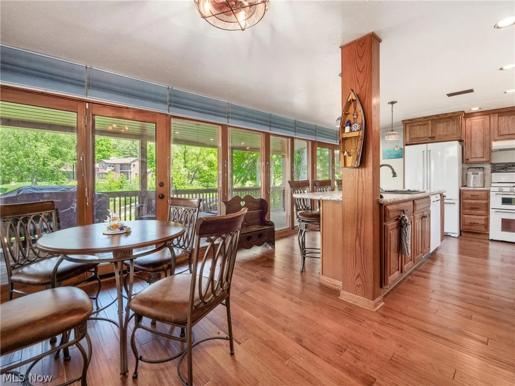 Dining room with a wealth of natural light, sink, and hardwood / wood-style flooring
