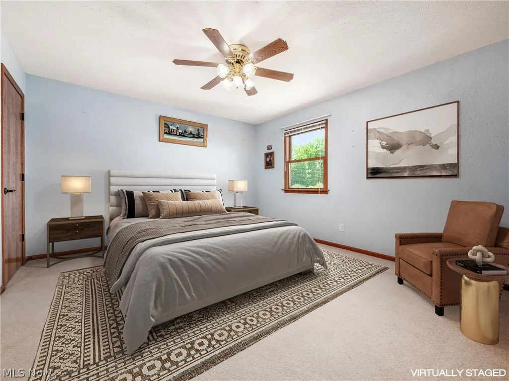 Bedroom featuring light colored carpet and ceiling fan