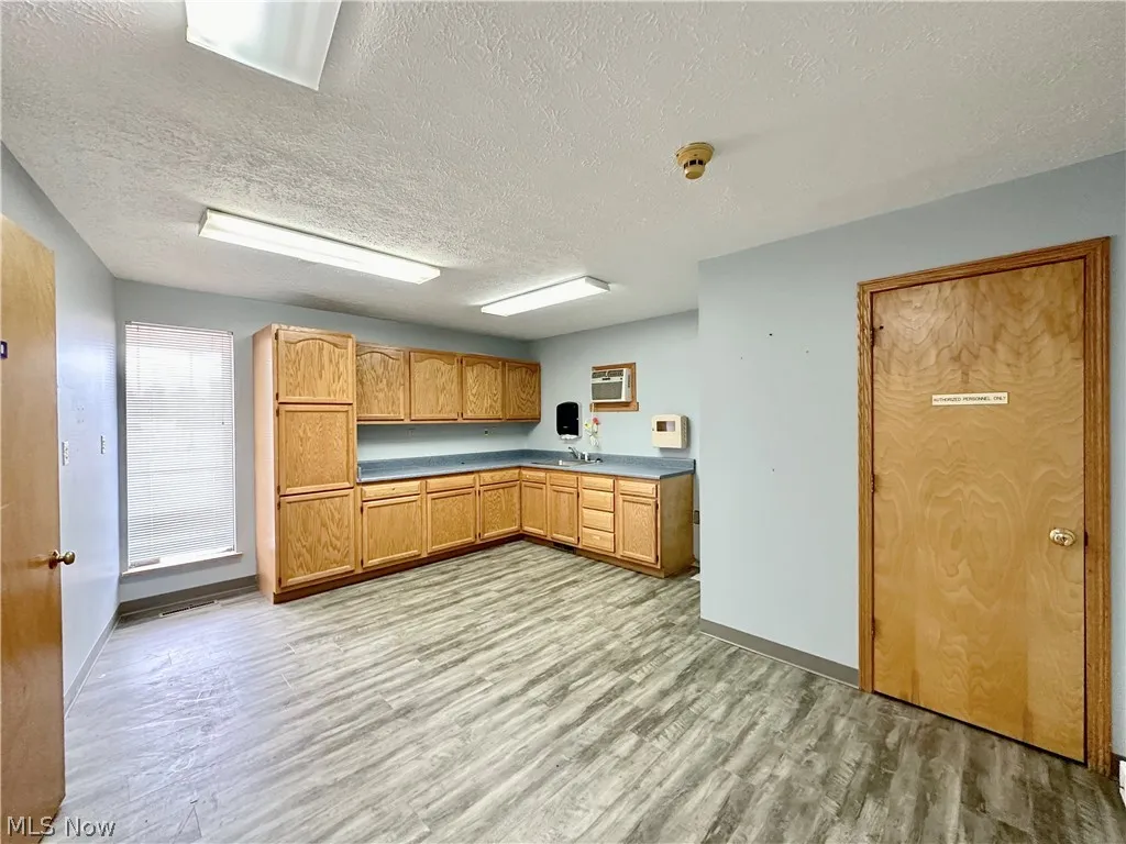 Procedure room with extra cabinetry for storage and closet storage