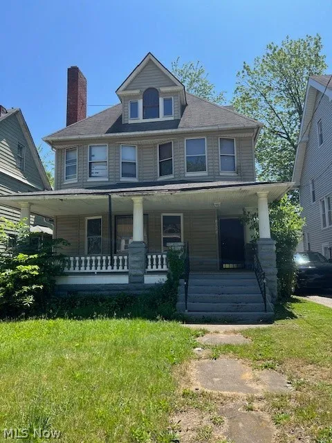 View of front facade featuring a porch and a front lawn
