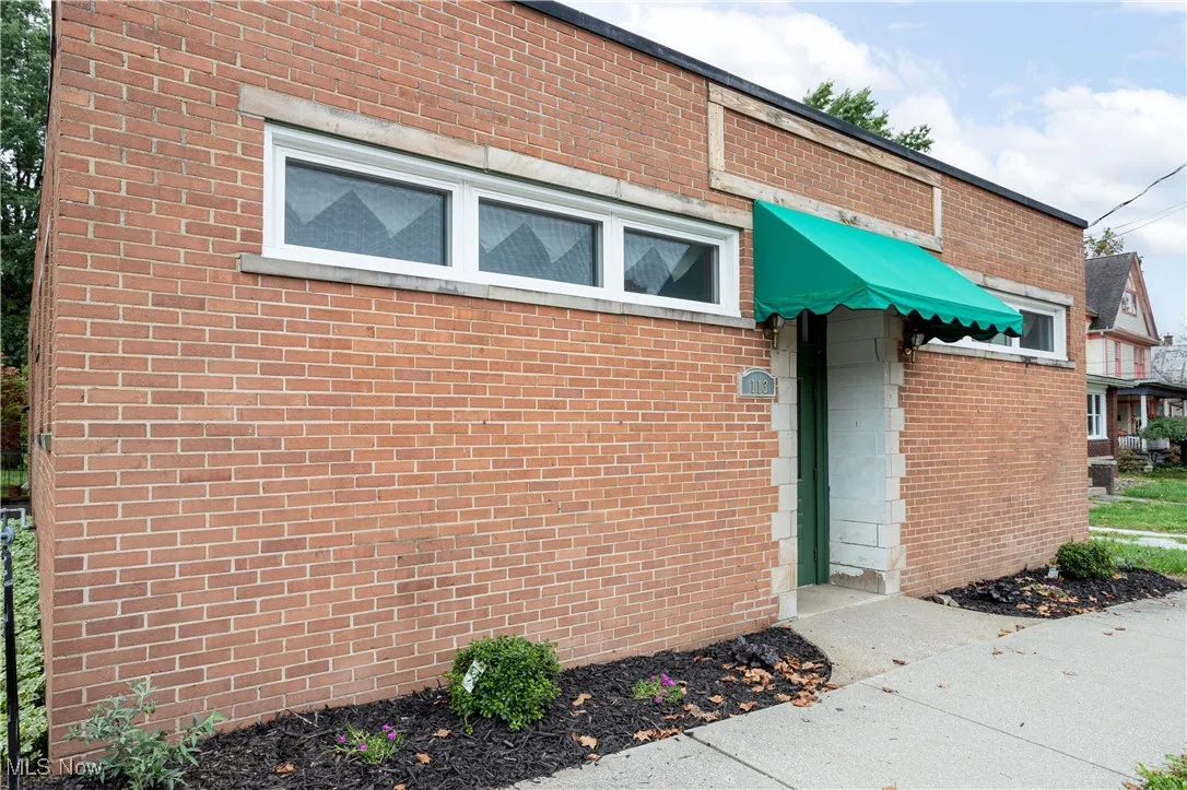 View of exterior entry featuring brick siding