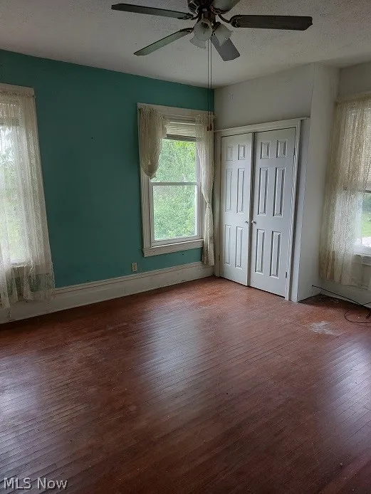 Spare room with ceiling fan and hardwood / wood-style floors