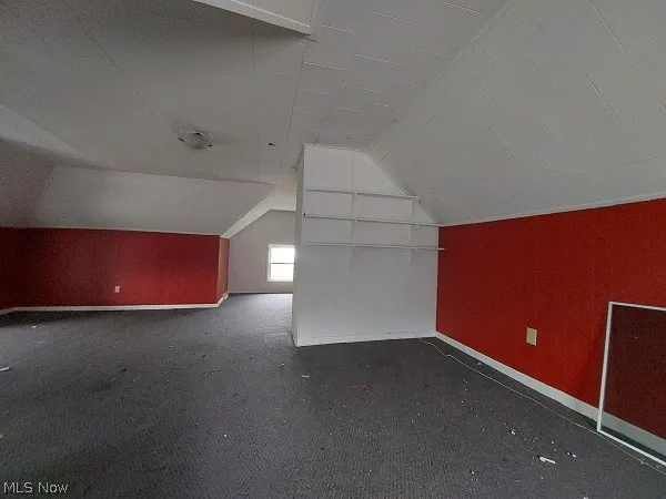 Bonus room featuring carpet and vaulted ceiling