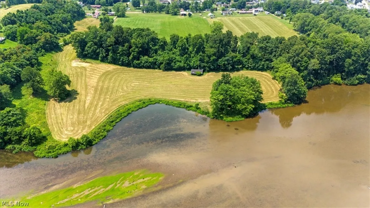 Birds eye view of property with a water view and a rural view