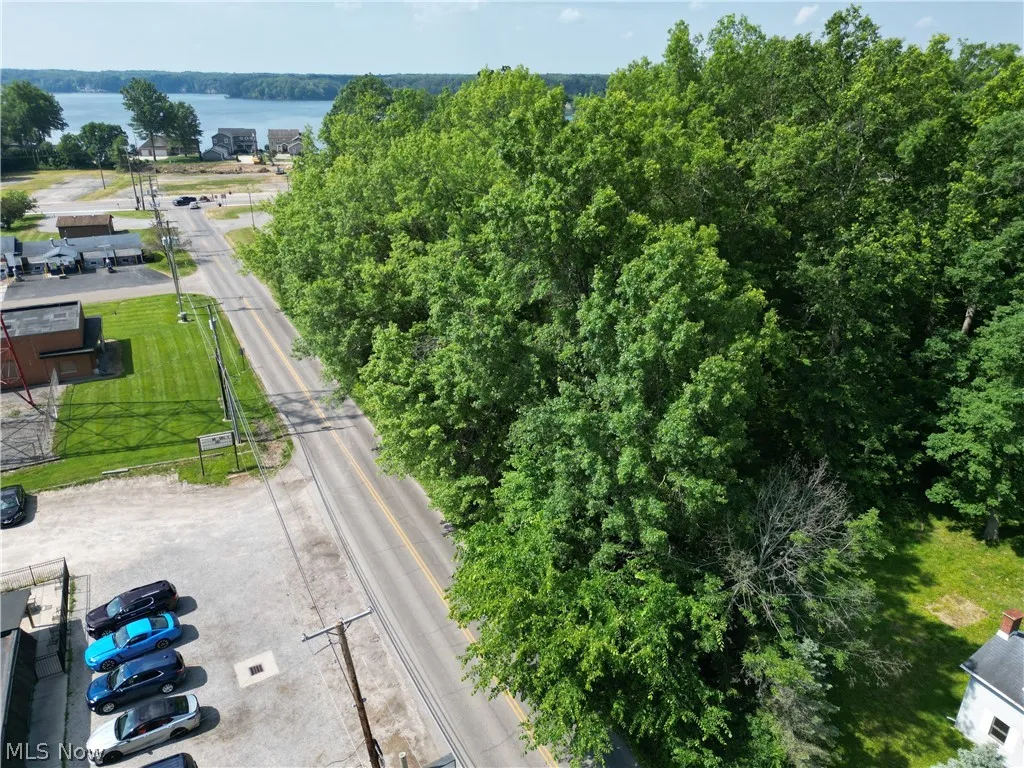 Birds eye view of property with a water view