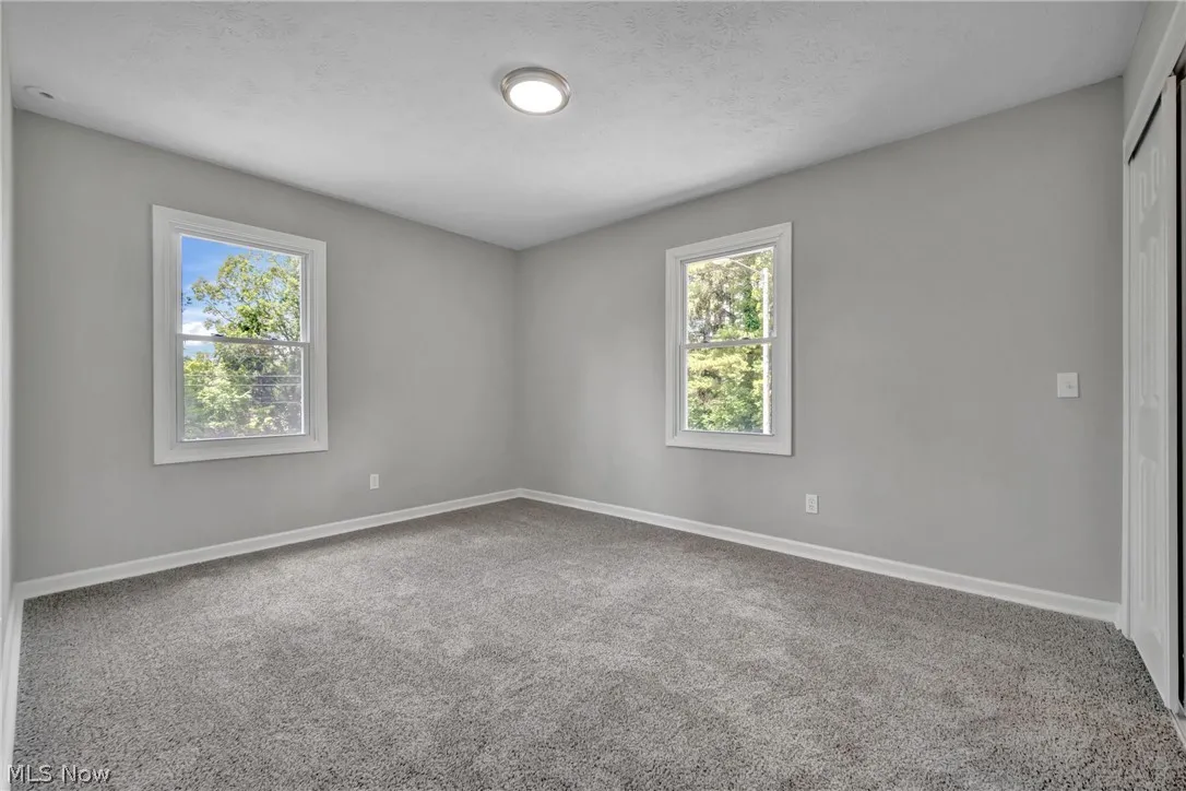 Carpeted bedroom featuring a textured ceiling