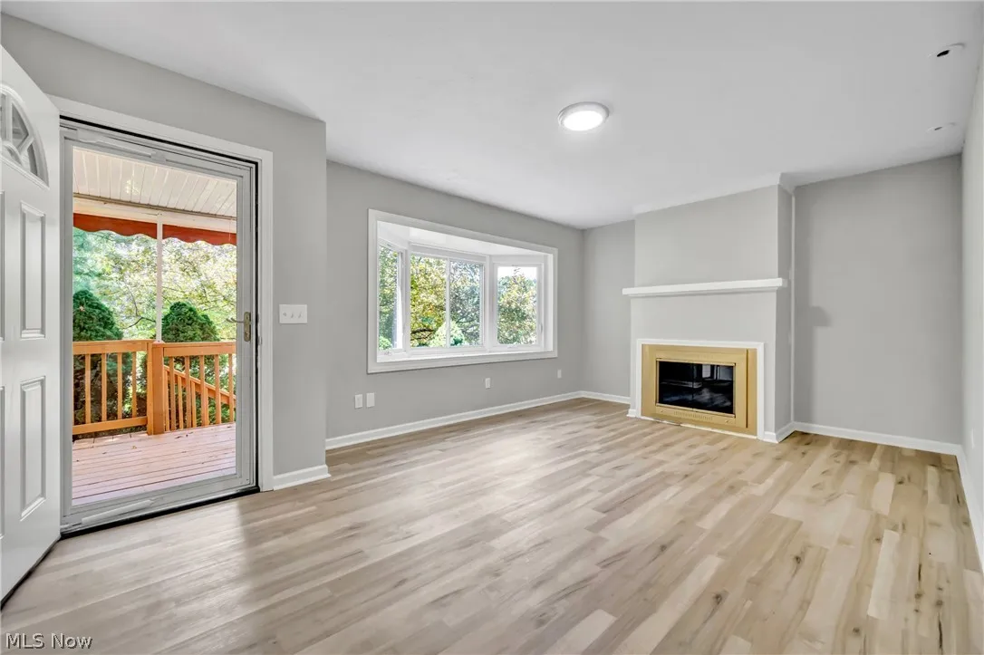 Unfurnished living room featuring light laminate wood-style flooring