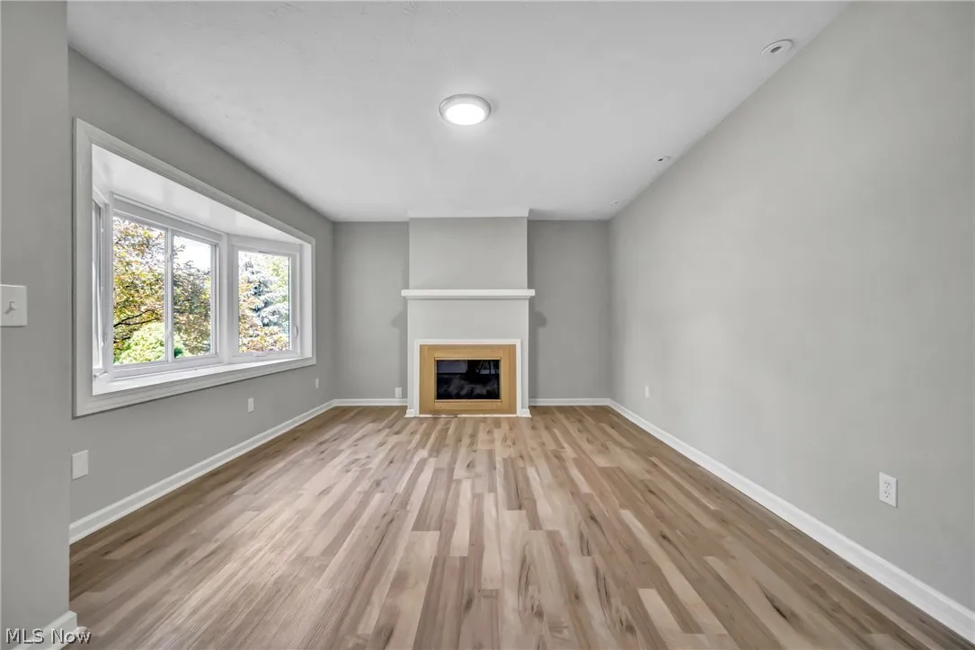 Unfurnished living room with laminate wood-style floors