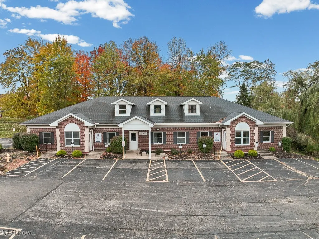 View of property featuring uncovered parking