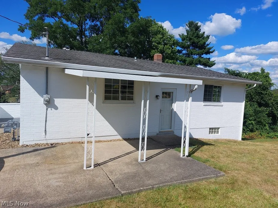 View of front of property featuring a front yard and a patio