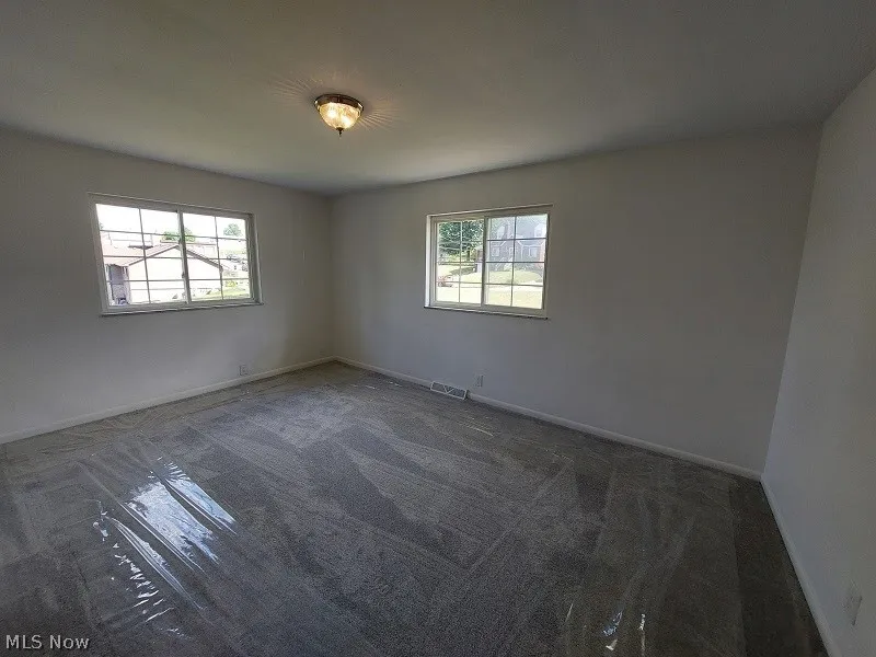 Spare room featuring carpet floors