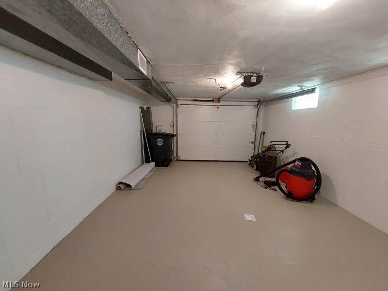 Garage featuring a garage door opener