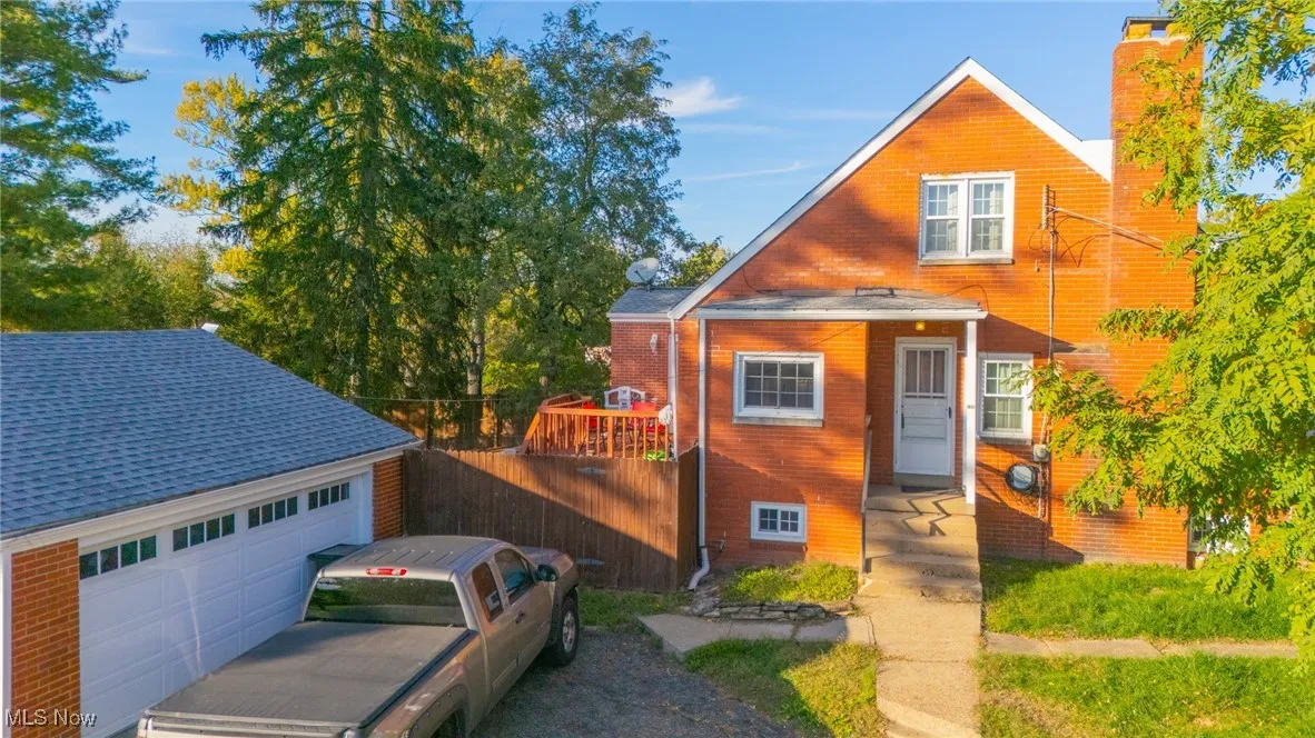 View of front of home with an outbuilding and a chimney