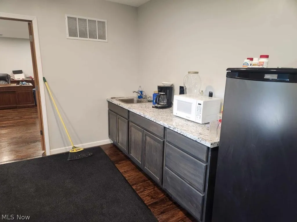 Kitchen with sink and wood-type flooring