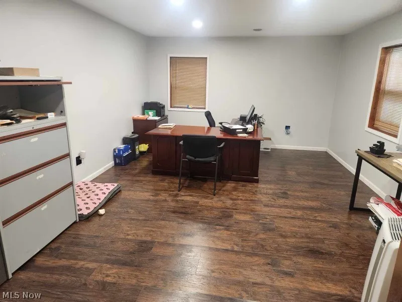 Office area featuring dark wood-type flooring