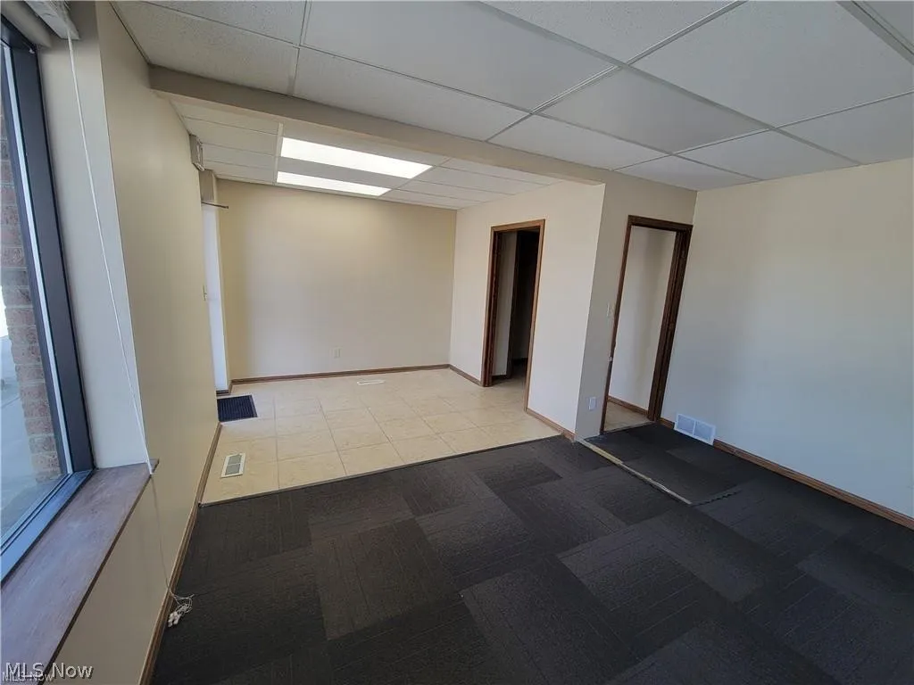 Spare room featuring a drop ceiling