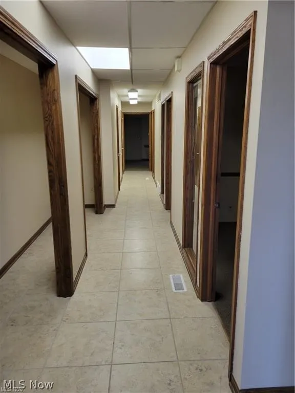 Corridor featuring light tile patterned floors