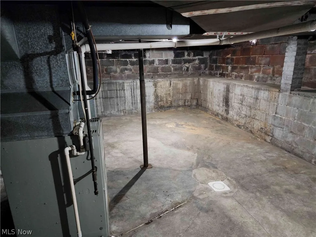Basement featuring heating unit