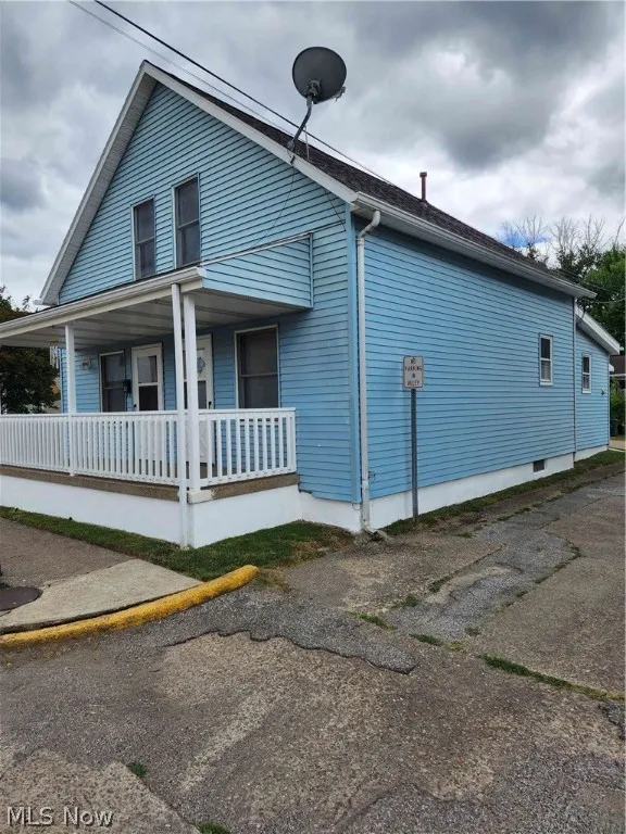 View of property exterior featuring covered porch