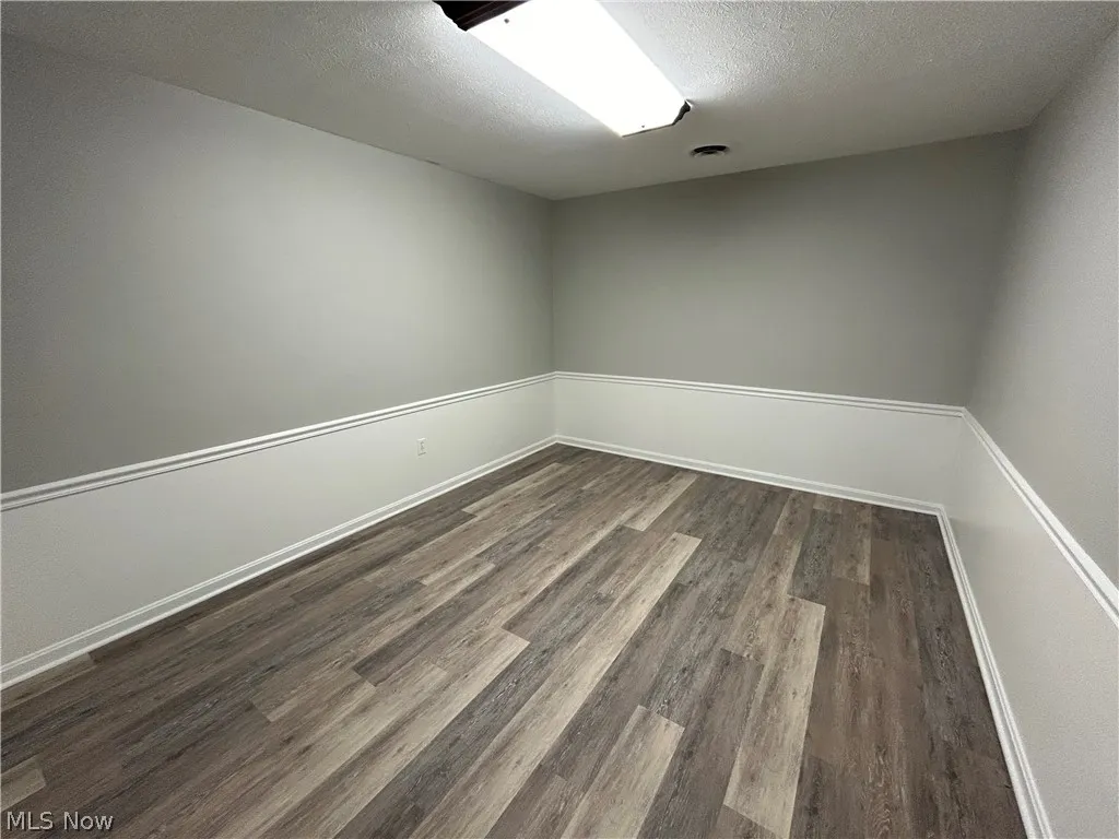 Unit A office with dark hardwood-style floors
