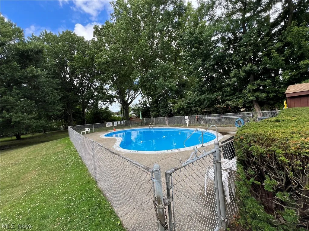 View of swimming pool with a yard