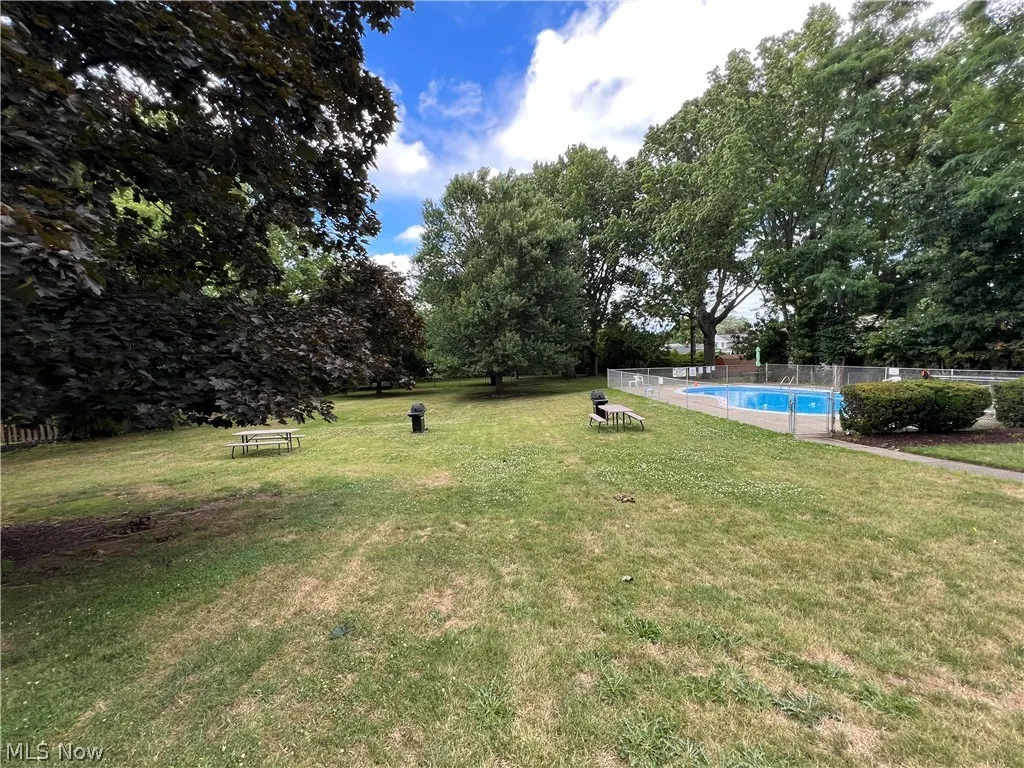 View of yard with a fenced in pool