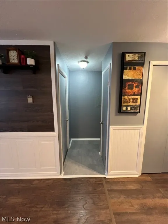 Corridor with dark hardwood / wood-style floors