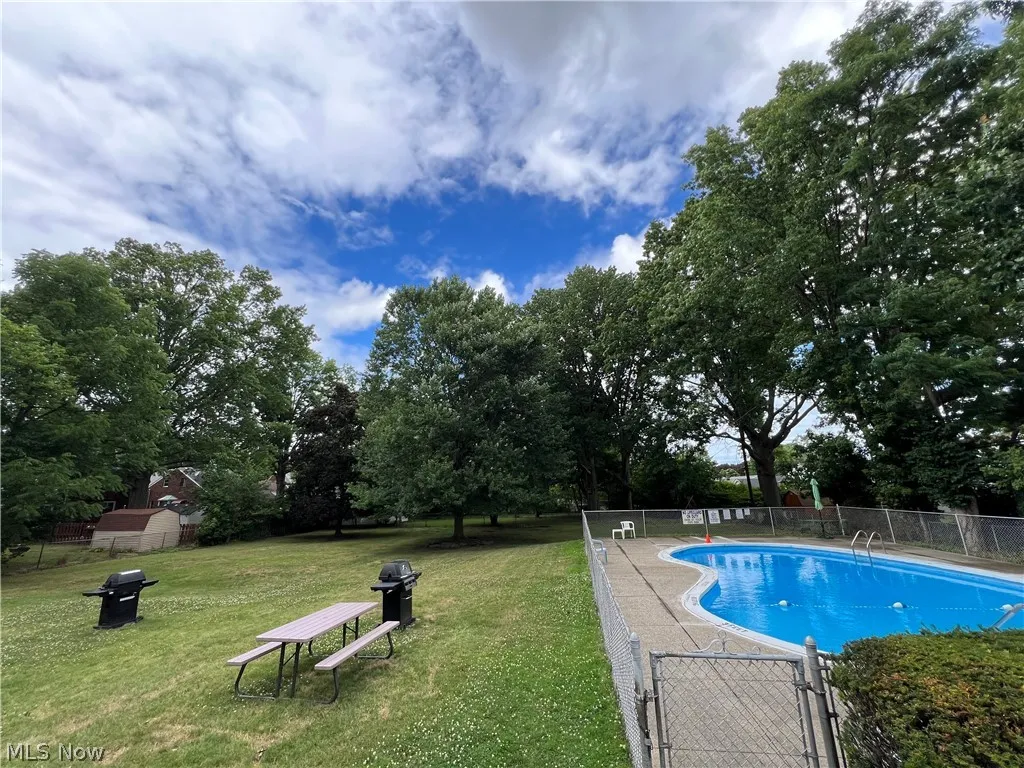 View of swimming pool with a lawn