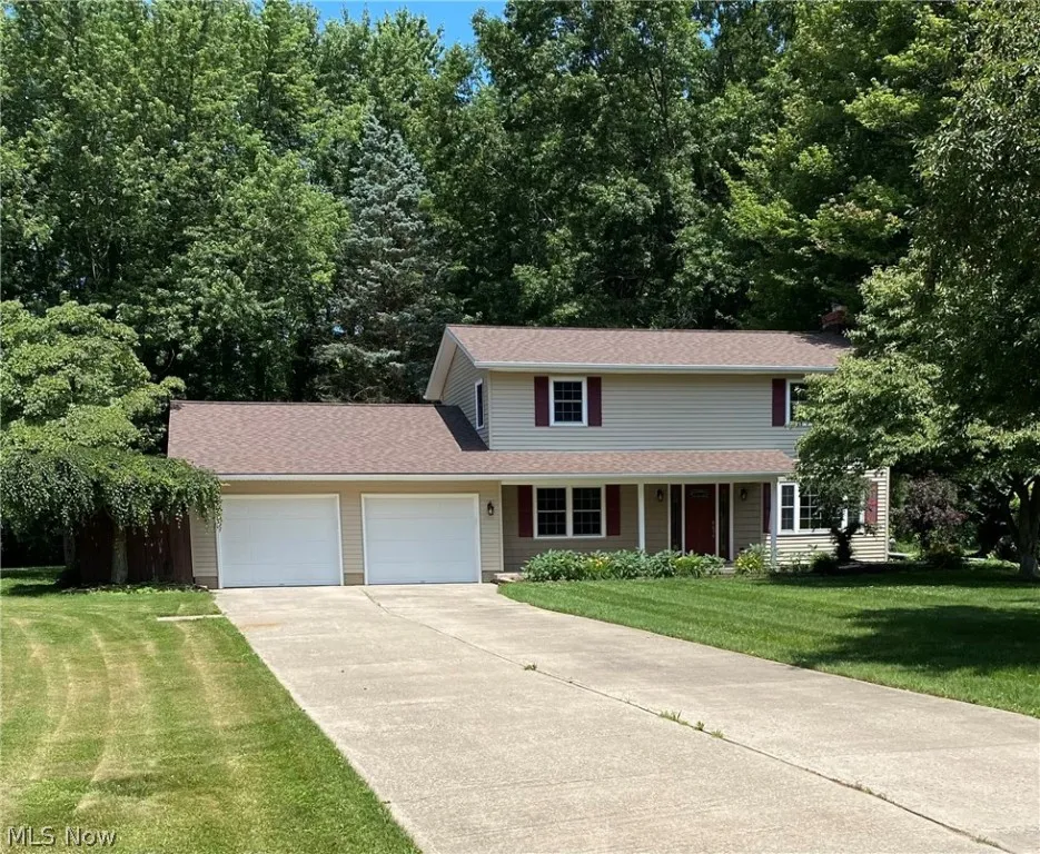 Front facade with a garage and a front lawn