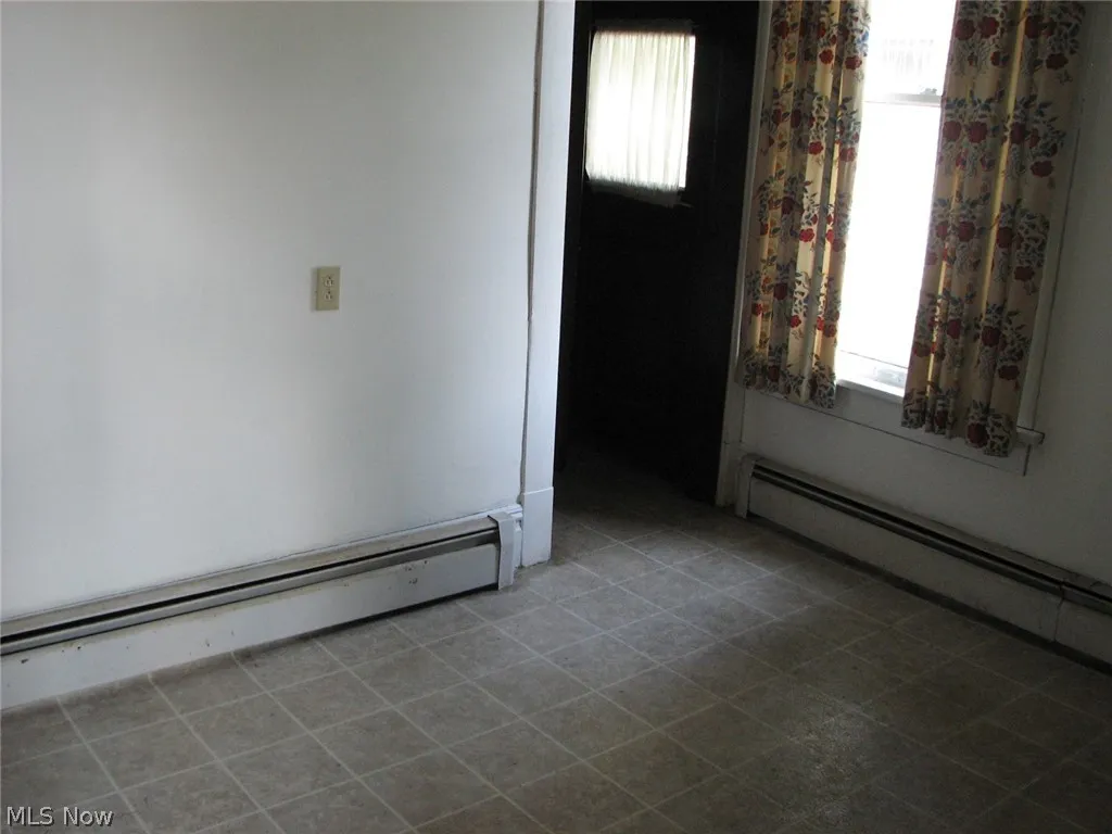 featuring a baseboard radiator and plenty of natural light