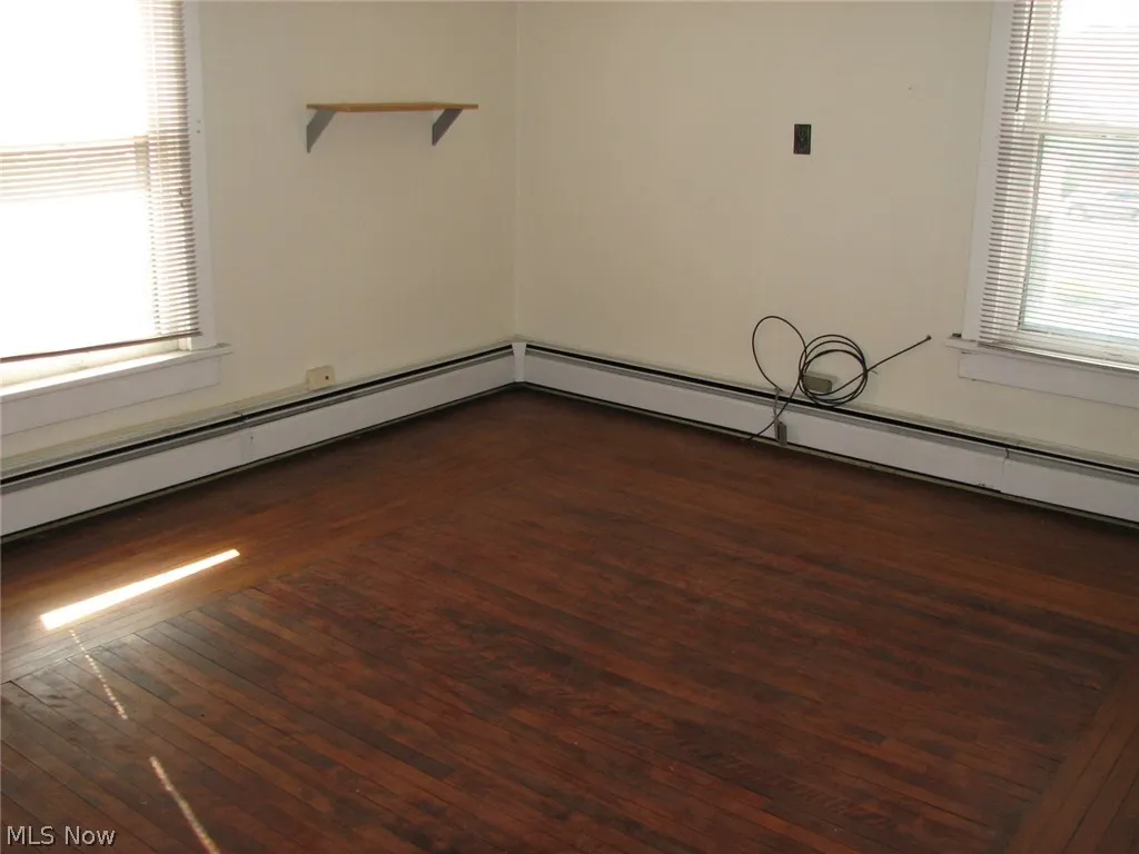 Spare room featuring dark hardwood / wood-style floors