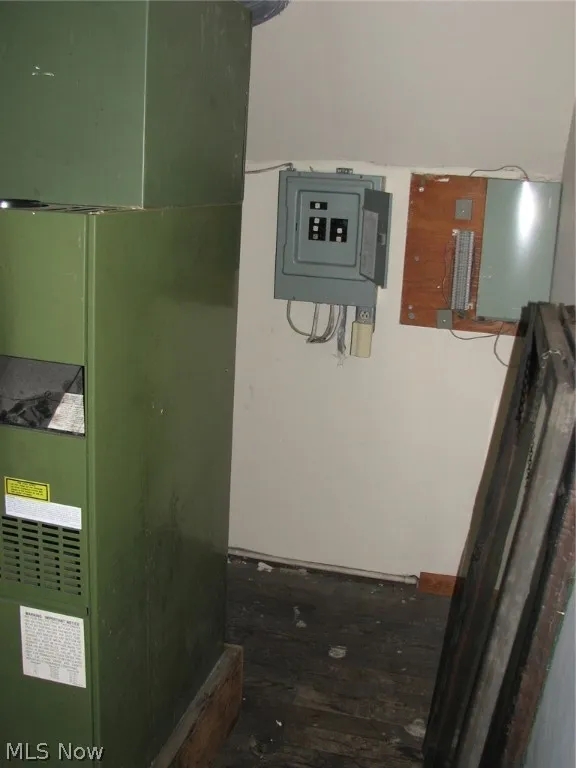Utility room featuring heating unit and electric panel