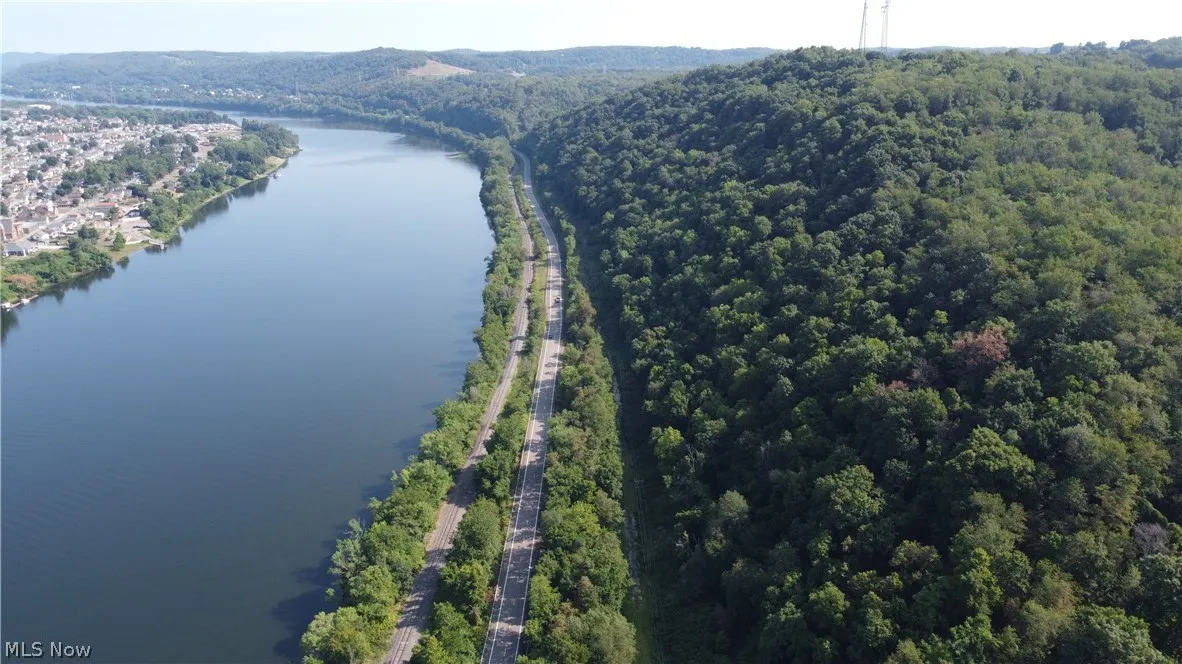 Birds eye view of property with a water view