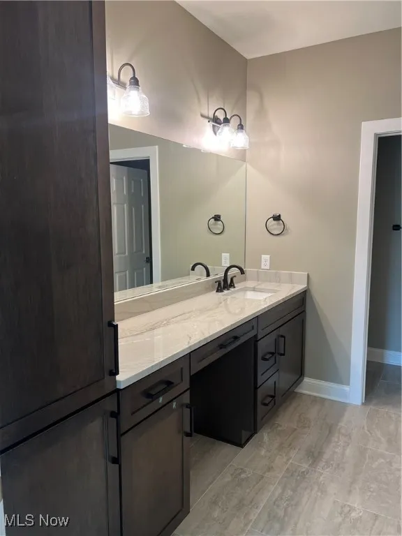 Bathroom featuring vanity and baseboards