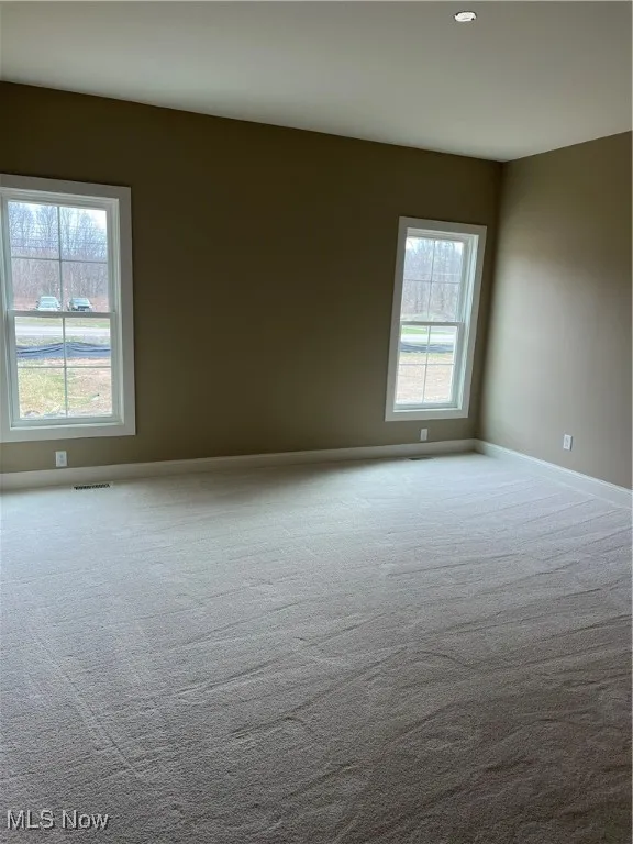 Unfurnished room with carpet