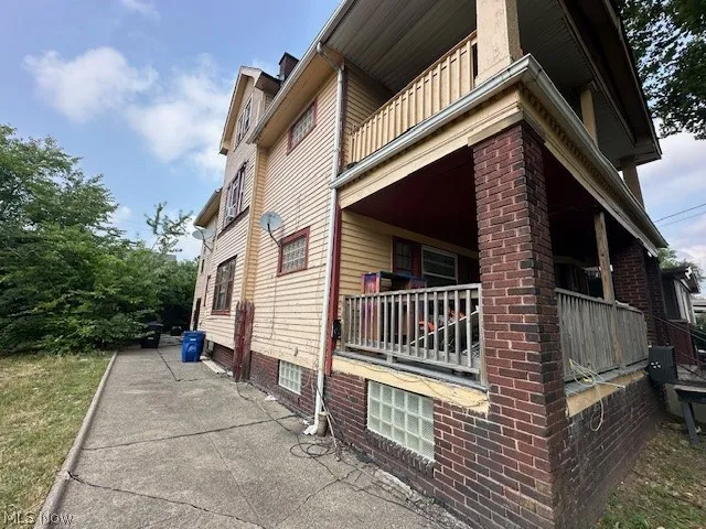 View of side of property featuring a balcony