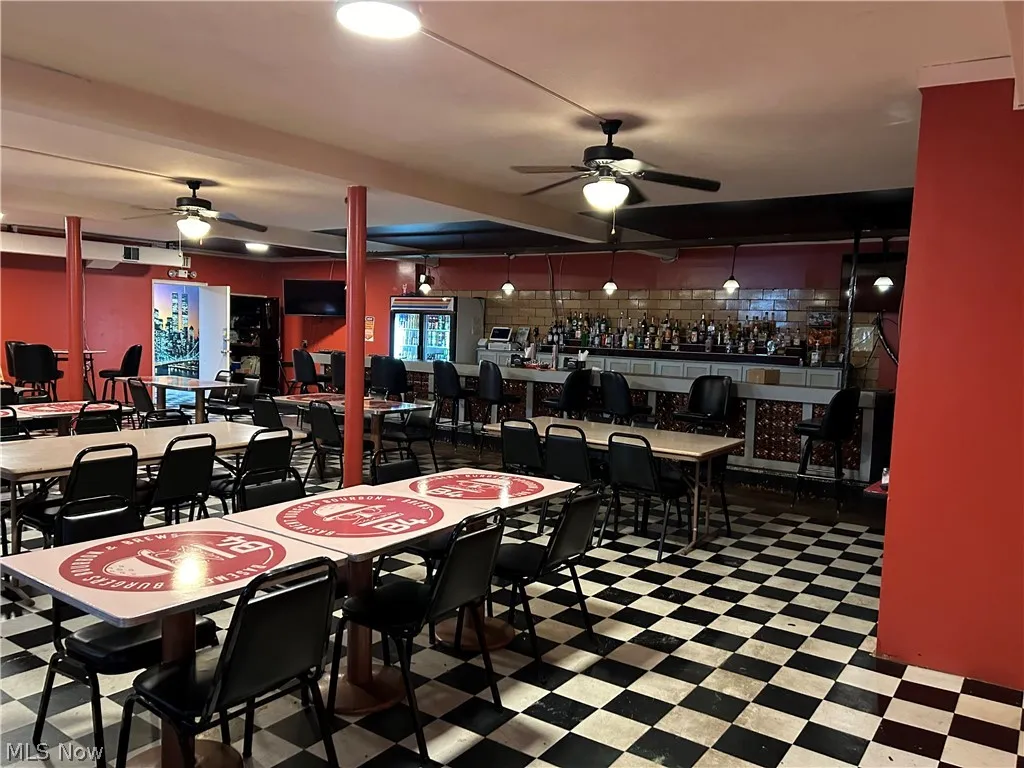 Dining area with bar and patterned floors and ceiling fan