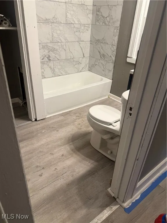 Bathroom with toilet and wood finished floors