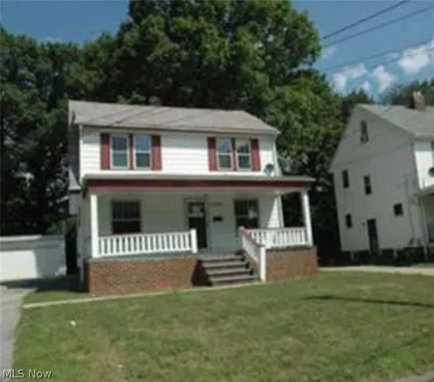 View of front of property with a porch and a front lawn