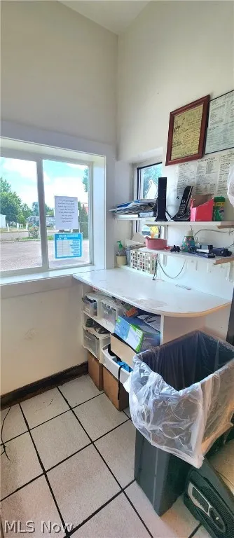 Home office with light tile patterned flooring