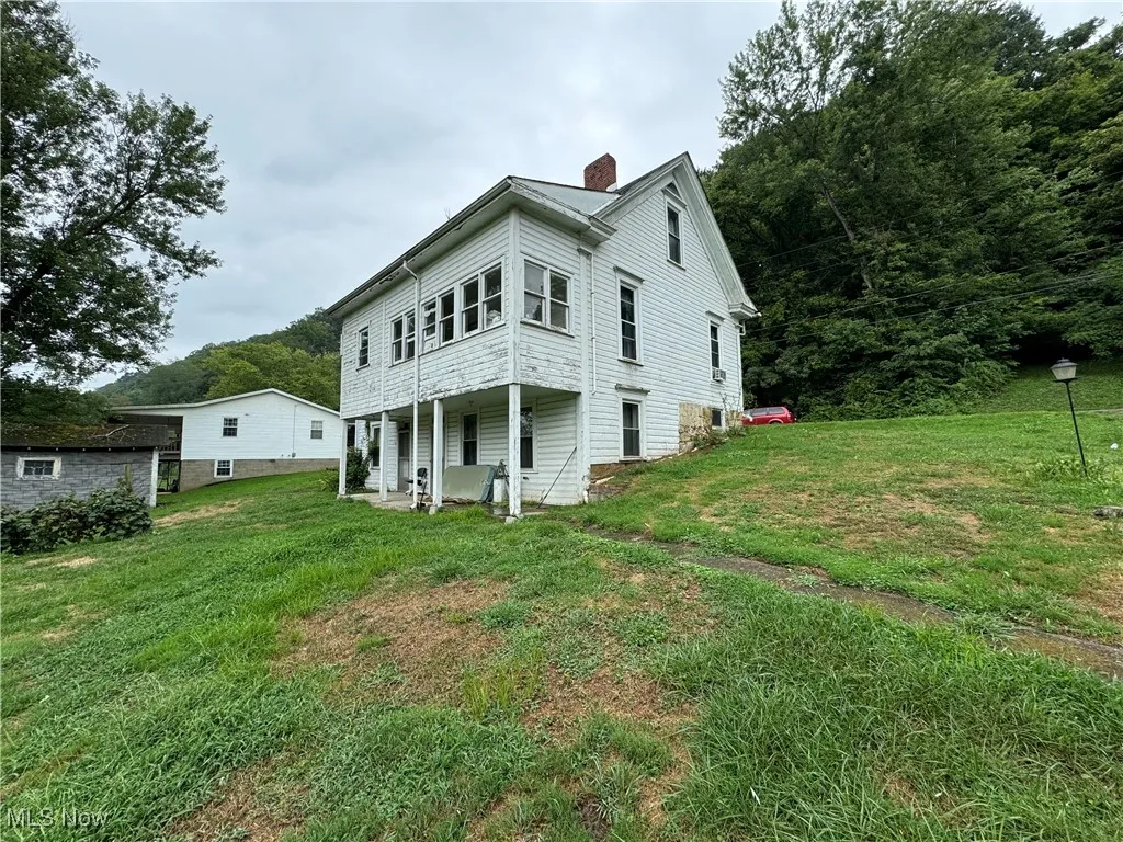 Back of house with a yard
