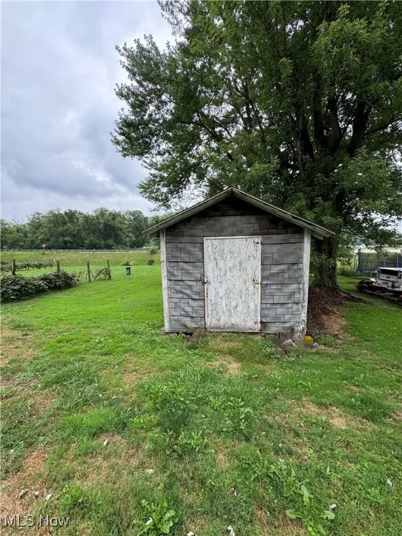 View of outdoor structure with a yard and a rural view